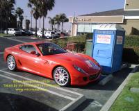 Ferrari parked next to a portable toilet